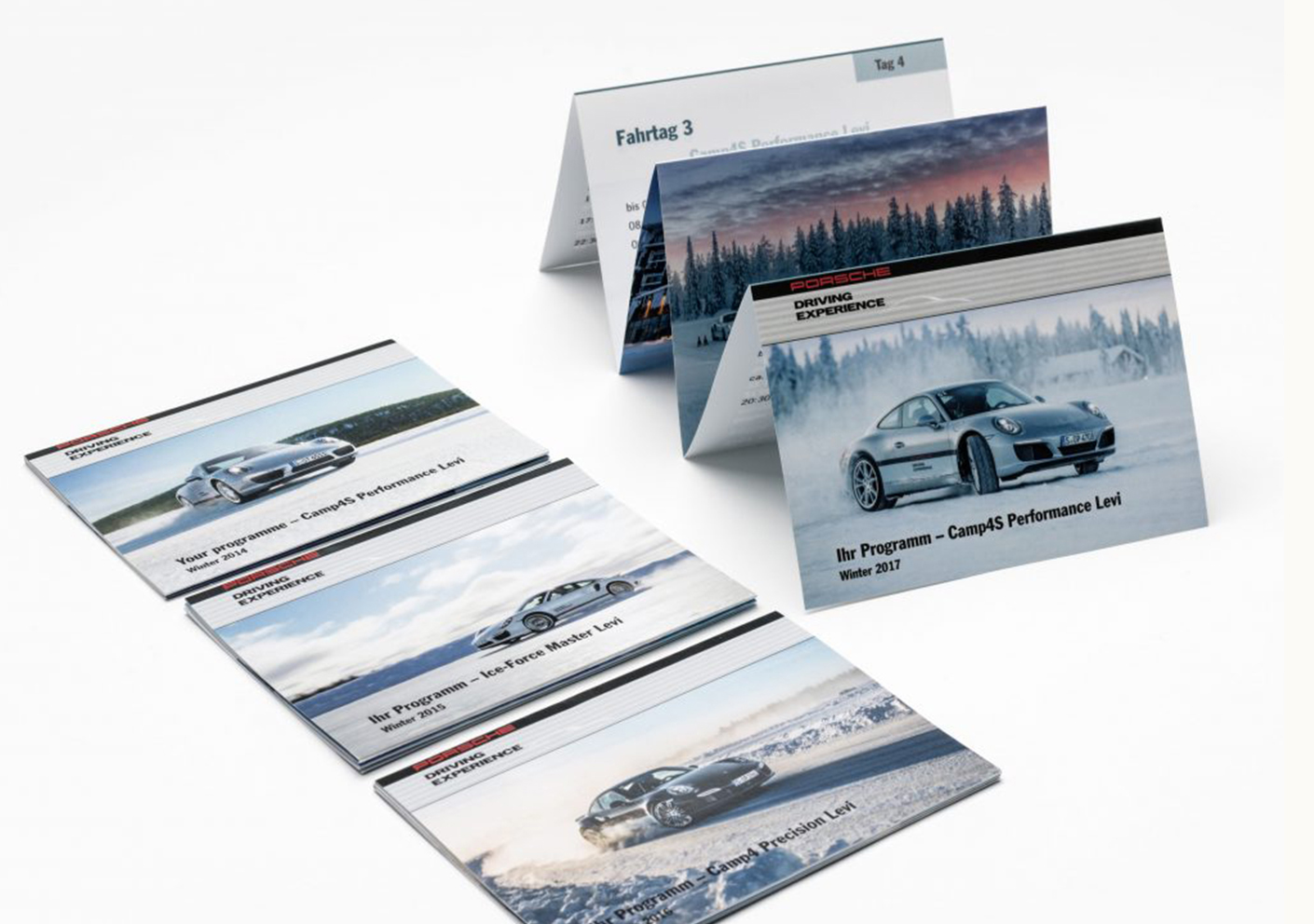 Broschüren des Porsche Driving Experience Programms mit verschiedenen Winter-Events und Leistungslevels, präsentiert in ansprechendem Design. Ideal für Motorsport- und Autofans.